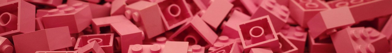 charles-snow-B0_HlgJ5-yk-unsplash Close-up of pink LEGO bricks piled together in a horizontal banner image